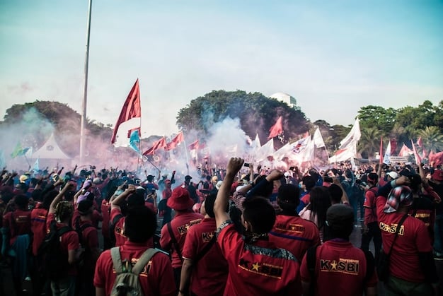 A professional Valorant team actively competing during a major tournament final, surrounded by a cheering Indonesian crowd, flags and team colors prominently displayed.