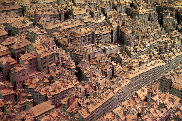 An aerial view of a well-organized Rise of Kingdoms city, with resource buildings clustered together and defensive structures strategically placed around the city walls.