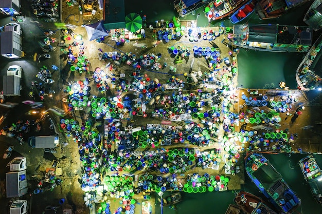 An aerial view of a bustling Indonesian e-sports event with enthusiastic crowds cheering for their favorite local gaming teams. The stadium is filled with energy and excitement, reflecting the growing popularity of e-sports and gaming culture in Indonesia.