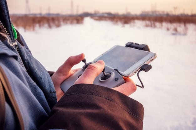 A player's hand adjusting the sensitivity settings on a mobile phone while playing Free Fire. The focus is on the fingers touching the screen and the sensitivity options being adjusted. The background shows the in-game environment.