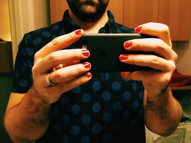 Close-up view of a player's hands skillfully controlling a Mobile Legends character on a smartphone, focusing on the joystick and skill buttons with a determined expression on their face